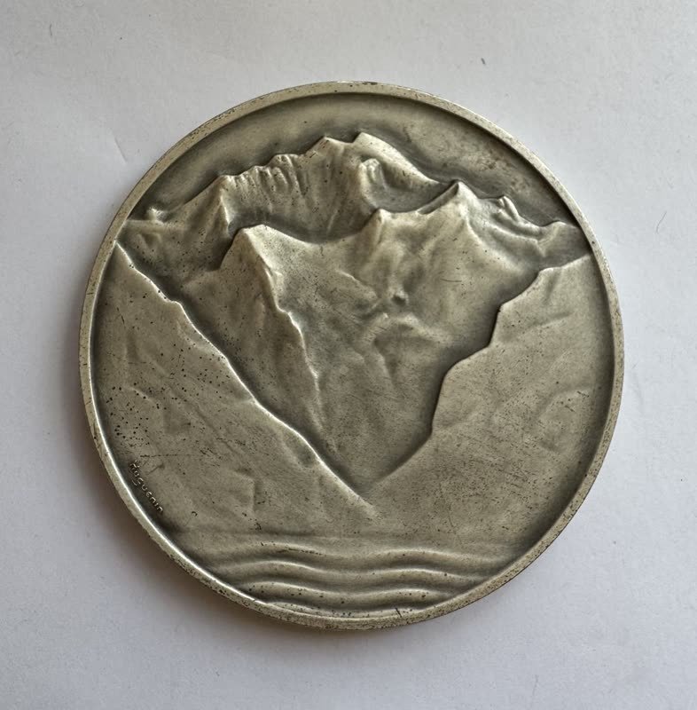 Rückseite mit zwei Erdhalbkugeln, Schweizerkreuz und der Umschrift Compagnie Suisse de Réassurances Zurich, 1863 bis 1938